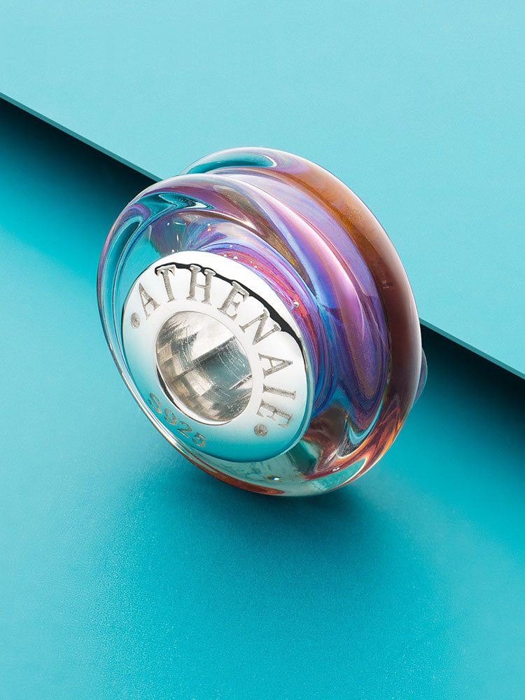 Sunset swirl Murano glass charm bead styled on bracelet