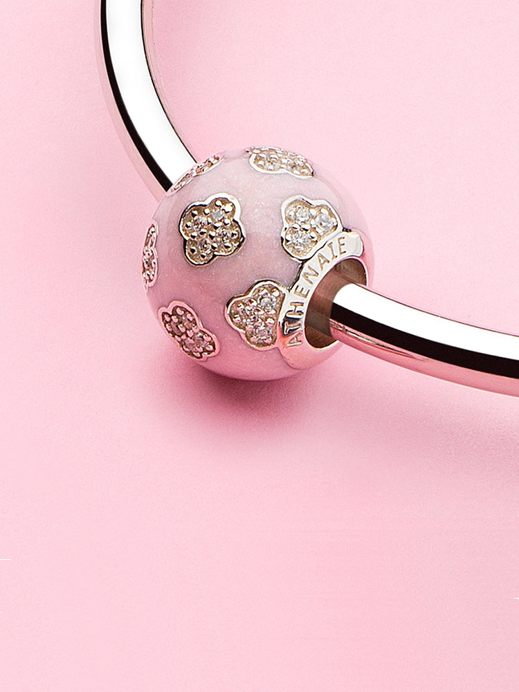 Sweet four leaf clover enamel charm bead styled on bracelet symbolizing luck