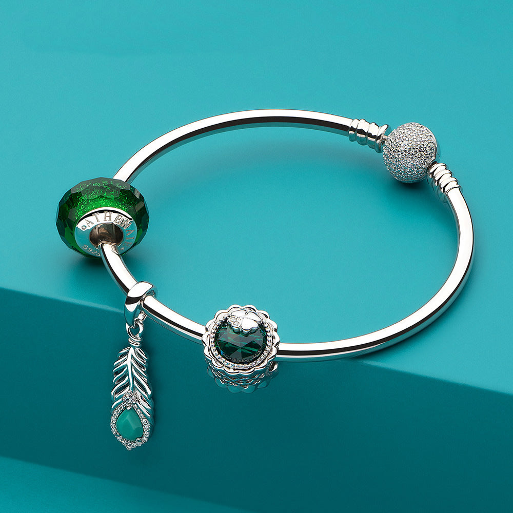 Close-up of Turquoise Feather CZ pendant charm with matching bracelet.