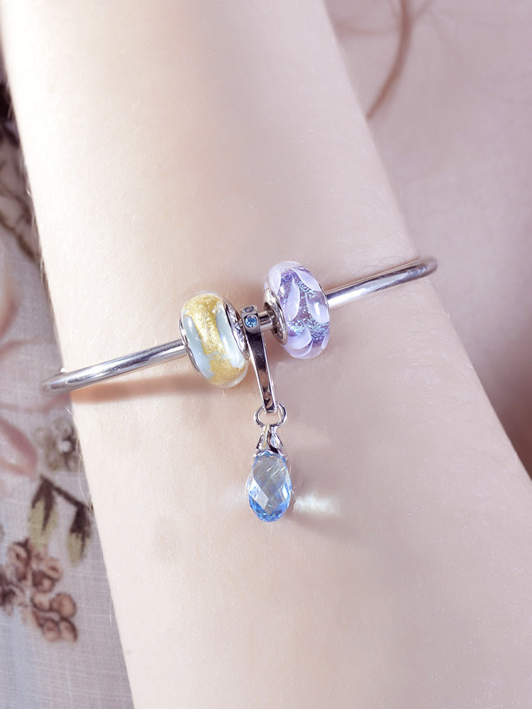 Close view of twilight petal murano glass charm on European style bracelet