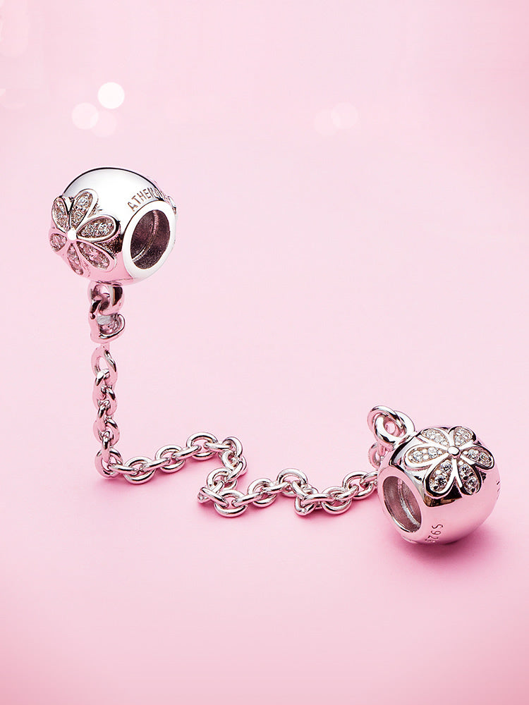 Twin Daisies sterling silver safety chain charm displayed on charm bracelet