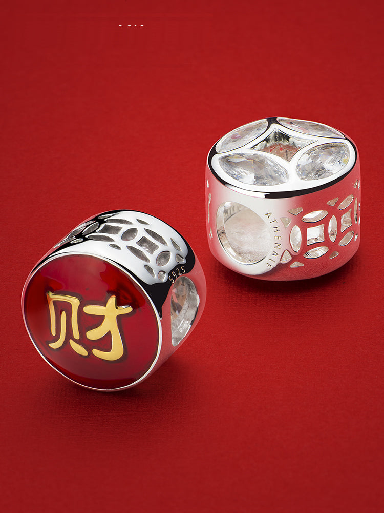 Wealth charm bead detail with gold enamel prosperity symbol